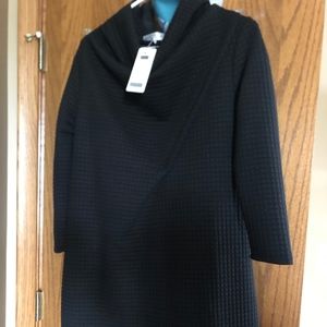 This is a pull over black waffle knit jacket